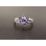TANZANITE AND DIAMOND CLUSTER RING the central tanzanite cluster flanked by diamond set shoulders,