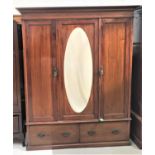 EDWARDIAN MAHOGANY AND INLAID WARDROBE with a moulded cornice above a central door with an oval