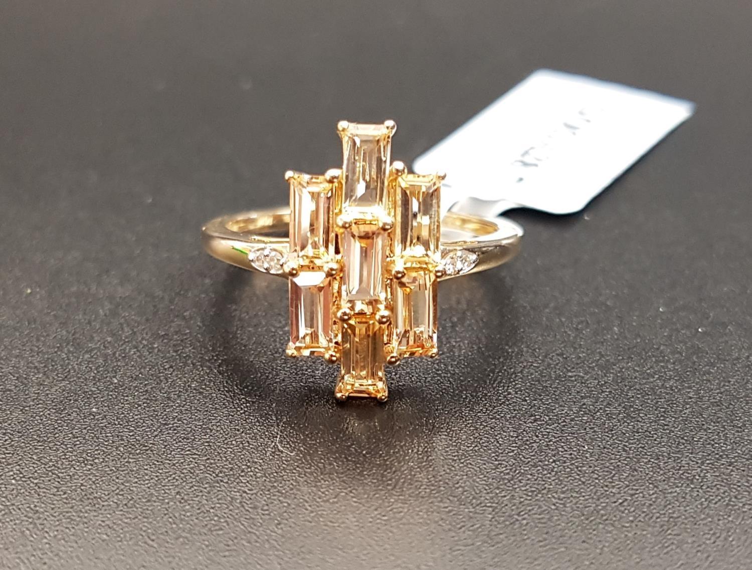 CERTIFIED TOPAZ AND DIAMOND CLUSTER RING the central panel of seven baguette cut Ouro Preto Imperial