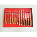 SET OF SIX STEAK KNIVES AND FORKS with horn handles, the blades marked 'Mutual Hiram Wild