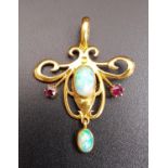 ART NOUVEAU RUBY AND OPAL SET FIFTEEN CARAT GOLD PENDANT the central oval cabochon opal flanked by a