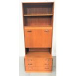 G PLAN ILLUMINATED TEAK WALL UNIT with two shelves above a fall flap, the base with three drawers,