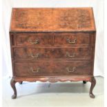 WALNUT AND FIGURED WALNUT BUREAU with a crossbanded fall flap opening to reveal a fitted interior