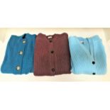 THREE HEAVY LAMBSWOOL CARDIGANS of various designs, in light blue, teal and orange/brown (3)