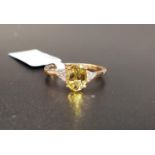 CERTIFIED GOLDEN BERYL AND DIAMOND RING the central oval cut Idar Golden beryl weighing 1.11cts,