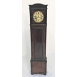EIGHT DAY GRANDMOTHER CLOCK in a stained oak case with an arched hood and circular dial with Roman