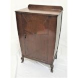OAK CUPBOARD with a shaped raised back above an inlaid cupboard door opening to reveal shelves,