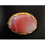 AGATE SET BROOCH the central oval orange and white agate secrion in unmarked gold mount, 4.5cm wide