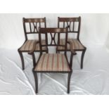 SET OF EIGHT MAHOGANY DINING CHAIRS with a concave top rail above a central X splat with stuffover
