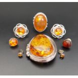 SELECTION OF AMBER SET JEWELLERY all set in silver, comprising a large brooch, a ring and three