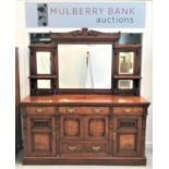 IMPRESSIVE WALNUT MIRROR BACK SIDEBOARD with a carved and shaped pediment centered with a shield