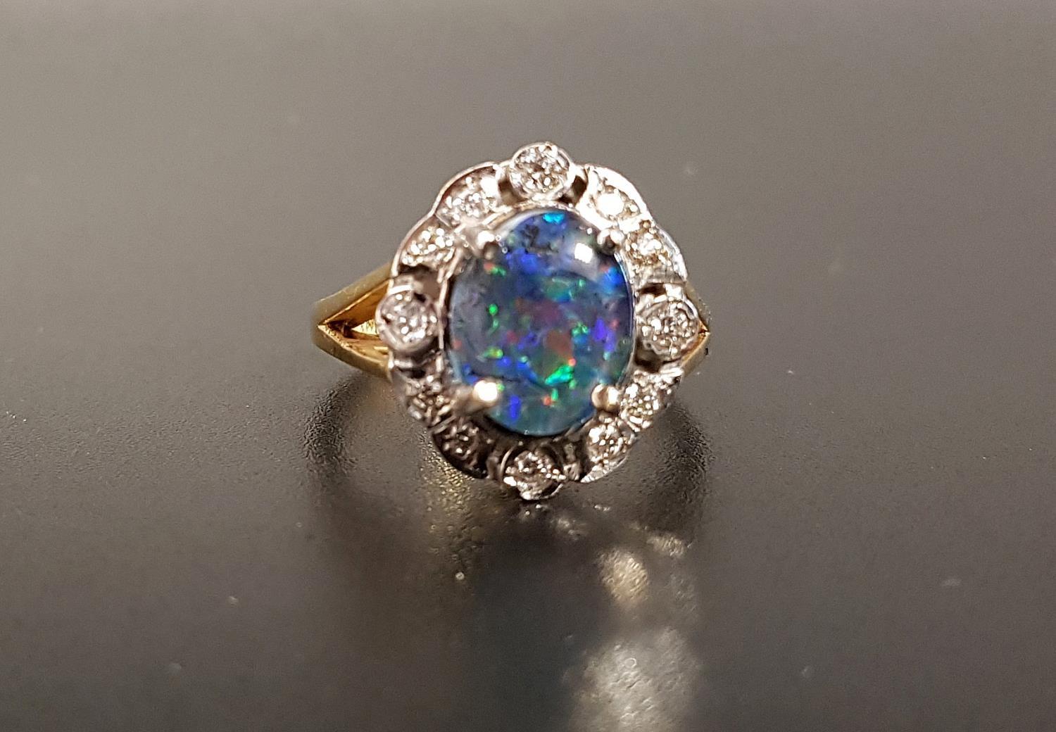 OPAL TRIPLET AND DIAMOND CLUSTER RING the central oval opal triplet approximately 1cm x 0.8cm, in