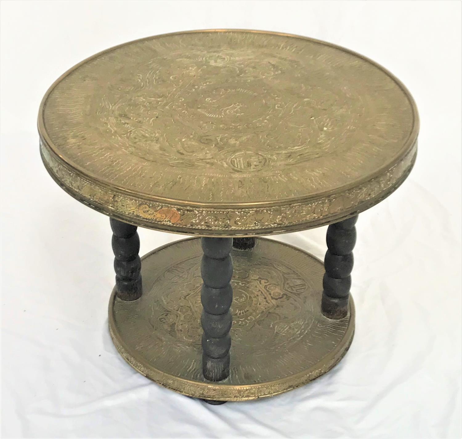 MIDDLE EASTERN OCCASIONAL TABLE with an embossed circular brass top on four bobbin turned supports