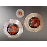 TWO CIARNGORM COLOURED GLASS SET PLAID BROOCHES both in white metal mounts with thistle