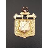 NINE CARAT GOLD MEDAL FOB the front with floral engraved decoration and the name W.H.Gibbons, the