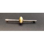 TIGER'S EYE BAR BROOCH set in nine carat white gold, 5.1cm long