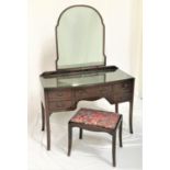 MAHOGANY BOW FRONT DRESSING TABLE with an arched mirror back above an arrangement of five drawers,