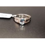 CERTIFIED AQUAMARINE AND DIAMOND RING the central oval cut Idar aquamarine weighing 0.68cts, flanked