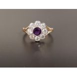 AMETHYST AND DIAMOND CLUSTER RING the central round cut amethyst approximately 0.4cts in eight