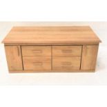 LIGHT OAK LOW SIDE CABINET with a moulded oblong top above four central drawers flanked by a pair of