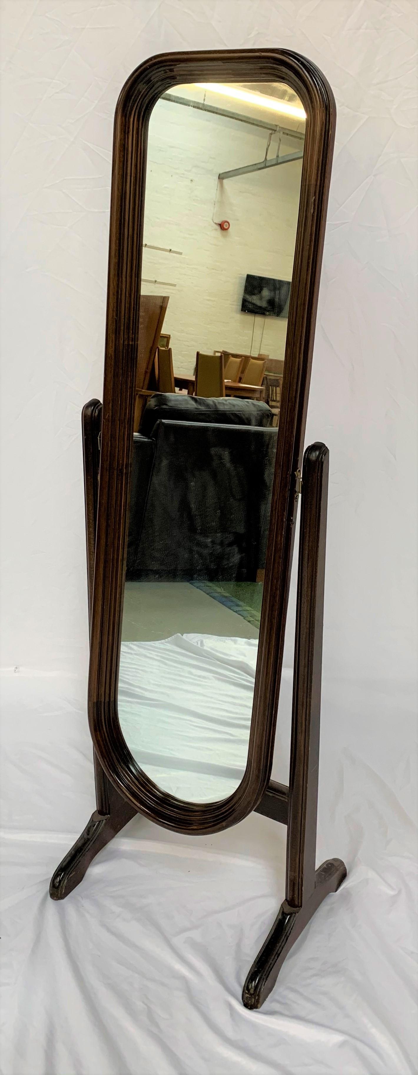 STAINED PINE CHEVAL MIRROR with an arched mirror on splayed supports, 143.5cm high