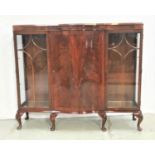 MAHOGANY BOW FRONT DISPLAY CABINET the moulded top above a central panelled door with a shelved