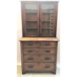 OAK BOOKCASE ON CHEST with a plain top above a pair of glazed doors opening to reveal adjustable