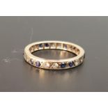 BLUE AND WHITE SAPPHIRE ETERNITY RING with alternating pairs of blue and white sapphires, in