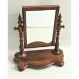 VICTORIAN WALNUT DRESSING TABLE MIRROR with a rectangular plate and cushion frame, with turned