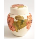 MOORCROFT LIDDED GINGER JAR decorated in the Hibiscus pattern with a cream ground, the base with