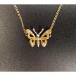 EIGHTEEN CARAT GOLD BUTTERFLY NECKLACE the pendant section formed as a diamond set two tone gold