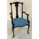 MAHOGANY ARMCHAIR with a carved and shaped top rail above a central pierced splat and shaped arms,