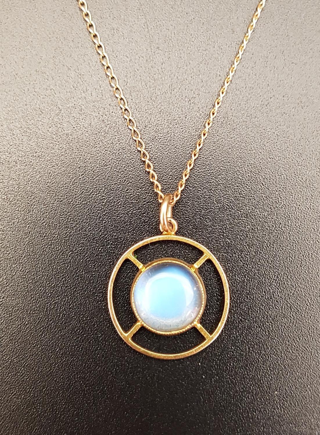 PRETTY MOONSTONE PENDANT the central round cabochon moonstone in pierced unmarked gold mount, on