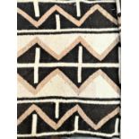 KELIM TYPE RUG with a brown and cream ground with a geometric pattern, 256cm x 133cm