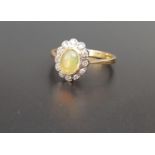 OPAL AND DIAMOND CLUSTER RING the central oval cabochon opal in lobed surround set with twelve