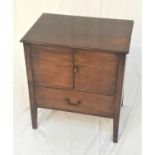 MAHOGANY BEDSIDE COMMODE with a moulded top above a pair of cupboard doors opening to reveal two