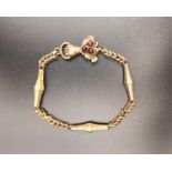 VICTORIAN UNMARKED GOLD FANCY LINK BRACELET the clasp with cabochon garnets and fist detail, total