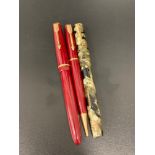 PARKER FOUNTAIN PEN with a claret coloured body marked Junior Duofold, the nib marked 14K, a