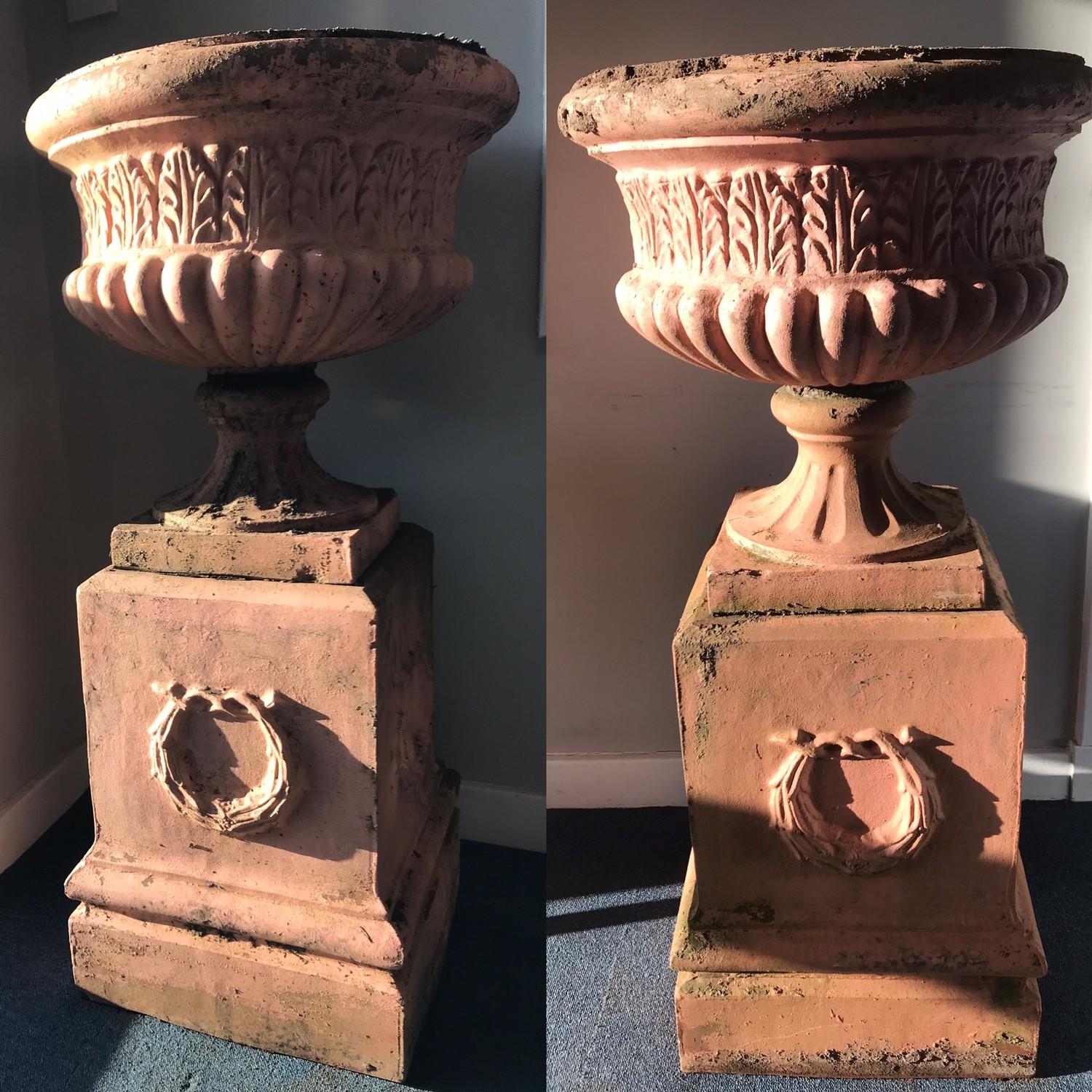 PAIR OF STONEWARE CAMPANA URNS each with lobed and reeded bodies, and raised on oblong bases with