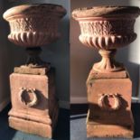 PAIR OF STONEWARE CAMPANA URNS each with lobed and reeded bodies, and raised on oblong bases with