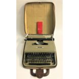 OLIVETTI LETTERA 22 PORTABLE TYPE WRITER in a fitted carry case, with cleaning brushes in a fitted