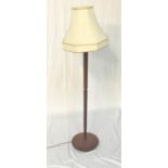 TEAK STANDARD LAMP raised on a circular base with a tapering grooved column and shaped cream