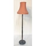 DARK OAK STANDARD LAMP raised on a circular base with flattened bun feet, with a turned column and