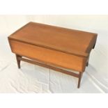 STONEHILL TEAK OCCASIONAL TABLE with an oblong top and shaped drop flaps, standing on shaped