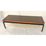 RETRO TEAK OCCASIONAL TABLE with a rectangular top and smoked glass cover, standing on a black metal