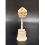 CHINESE CARVED IVORY PUZZLE BALL on a two piece carved and turned stand, 13.5cm high
