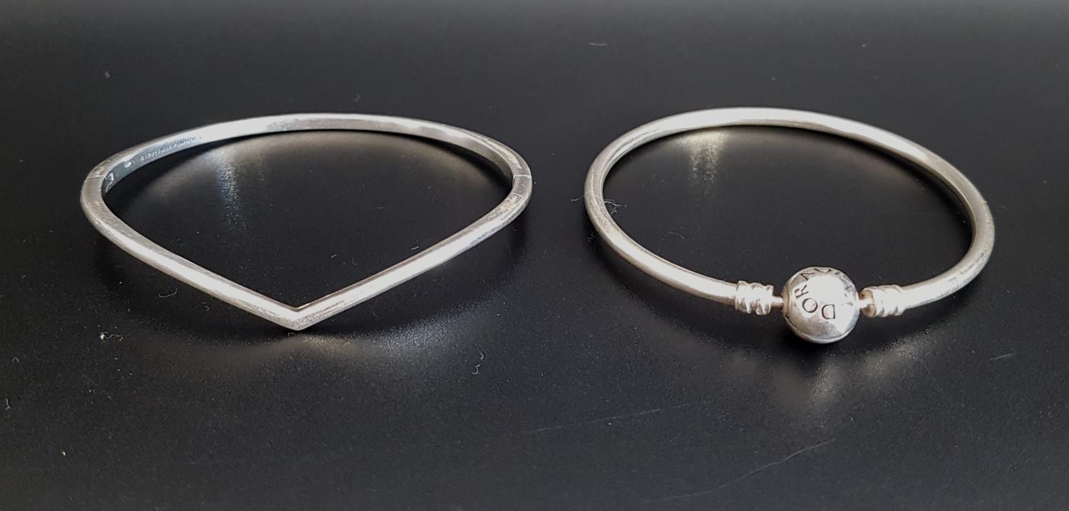 TWO PANDORA SILVER BRACLETS comprising a Moments charm bangle and a Shining Wish bangle (2)