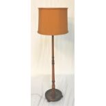 OAK STANDARD LAMP raised on a circular base with flattened bun feet with a turned column and