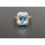 BLUE TOPAZ AND DIAMOND CLUSTER DRESS RING the central emerald cut blue topaz approximately 3.3cts in