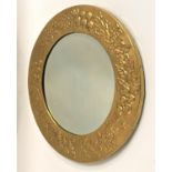 CIRCULAR WALL MIRROR with a brass embossed frame decorated with flowers and fruit around a beveled